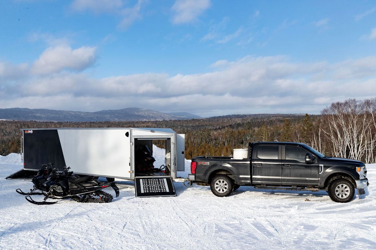 SnoPro Enclosed Deckover 6.5 Height Snow Trailers Rear and Front Doors Open With Snowmobiles SnoPro Enclosed Deckover 6.5 Height Snow Trailers Rear and Front Doors Open With Snowmobiles