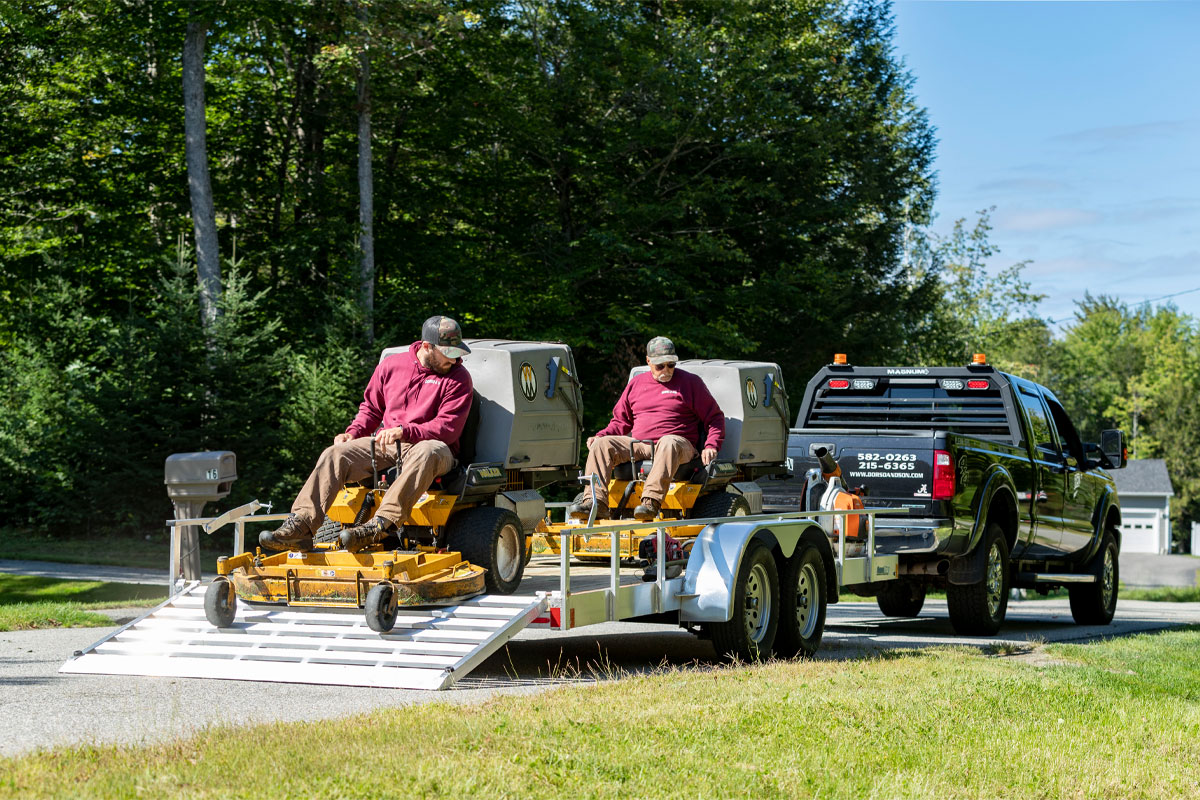 Unloading Two Tractors Off Utility Landscape Wood Deck 2.0 Trailer